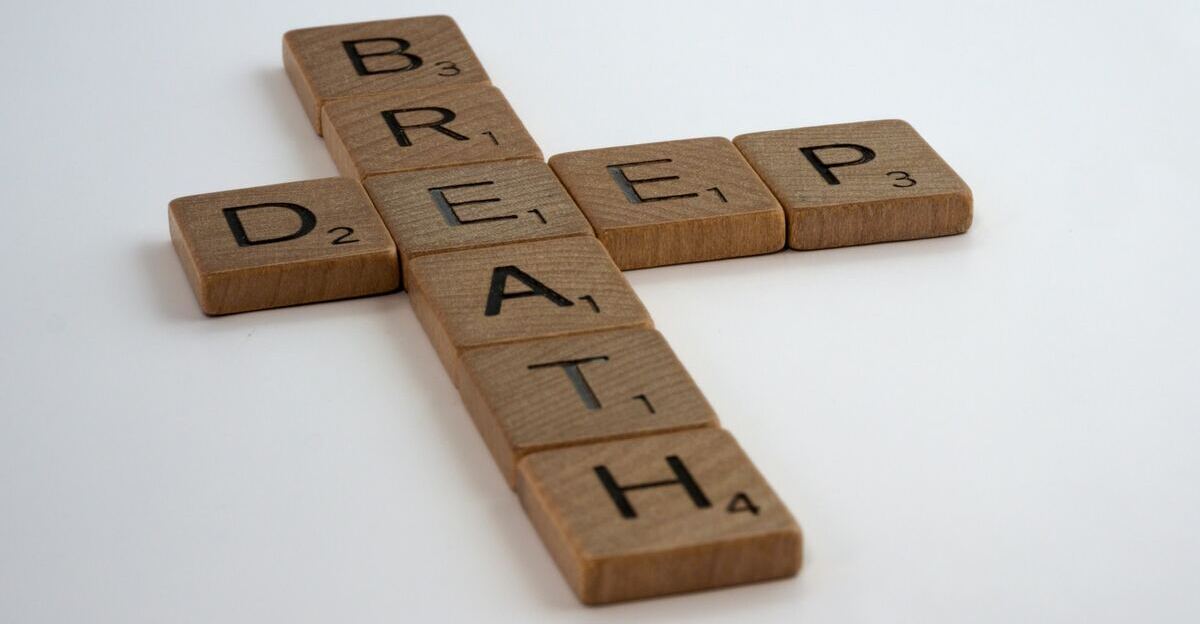 A couple of words spelled out using plain brown Scrabble tiles. It says “deep” horizontally, and “breath” vertically.