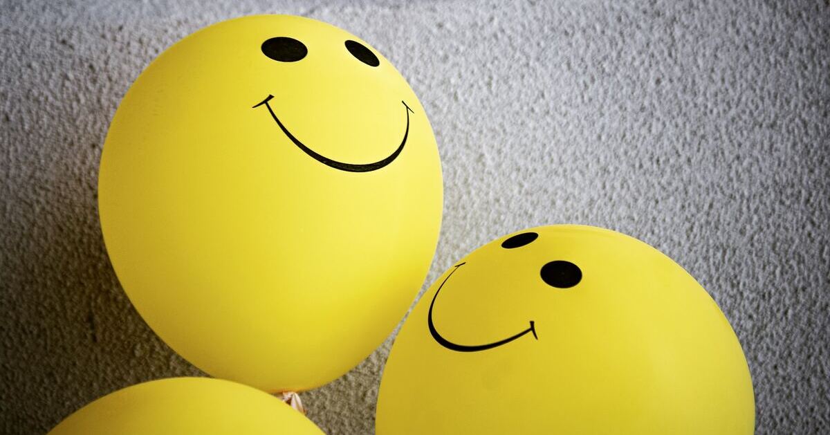Three yellow balloons featuring a smiley face.