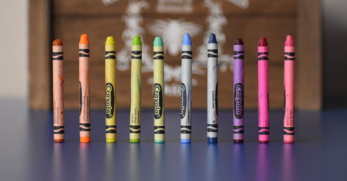 Ten crayons standing on their own and in different colors.